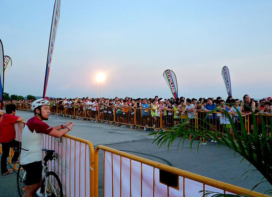 The staggering trail of runners before flag-off at the HomeTeamNS-New Balance REAL Run 2011
